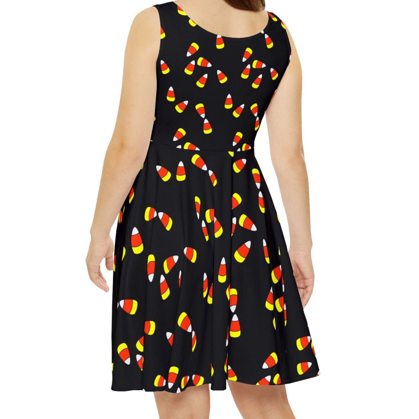 Woman wearing a black dress with candy corn pattern on it, Halloween, fall, teacher dress, fun fall dress, candy corn dress, Halloween costume alternative. 